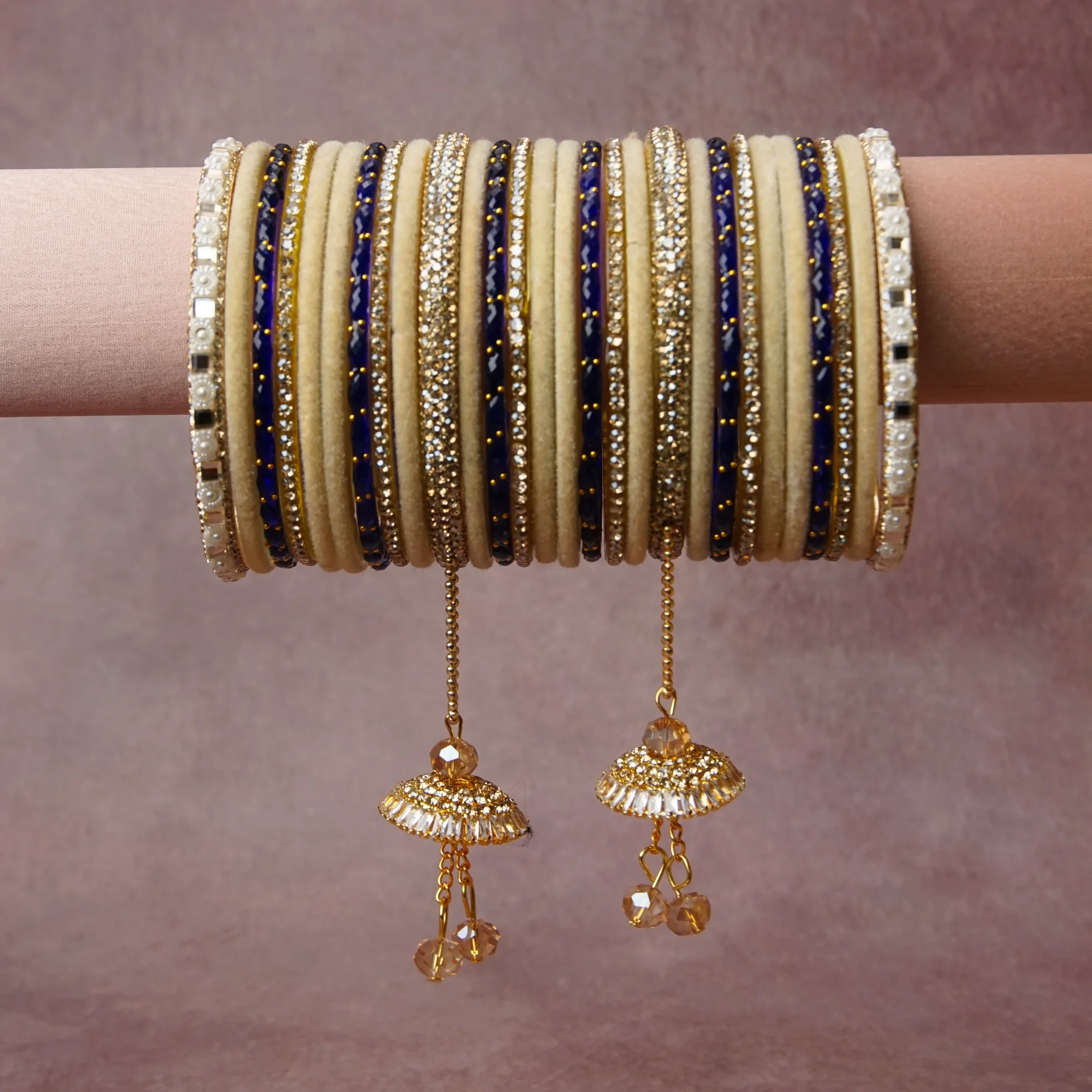 A grounding Cream forms the heart of the set, while touches of Gold, Clear Crystal add charm.

A thoughtful composition of Velvet, Gold-toned Metal, Cubic Zirconia, Simulated Pearl, Enamel, Faceted Glass, designed to feel complete without being heavy.
Each element layers seamlessly, creating a look that is refined, wearable and quietly striking.